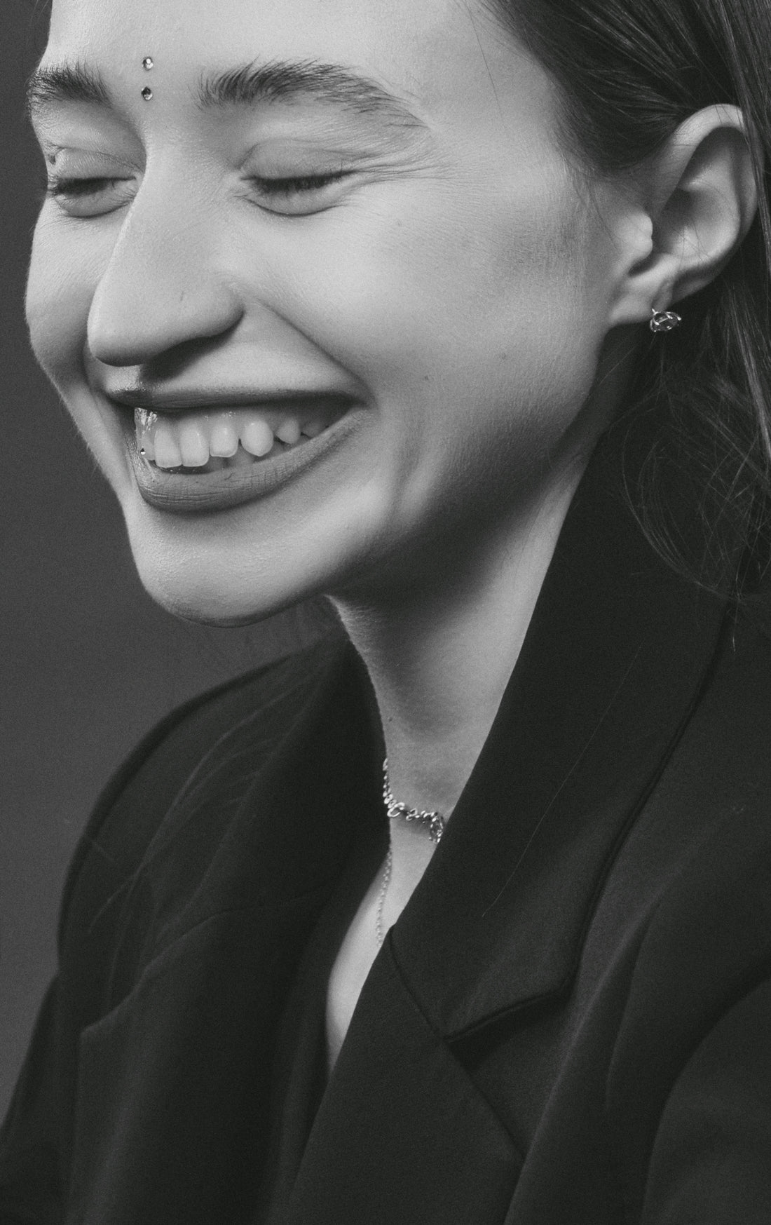 a black and white photo of a woman smiling